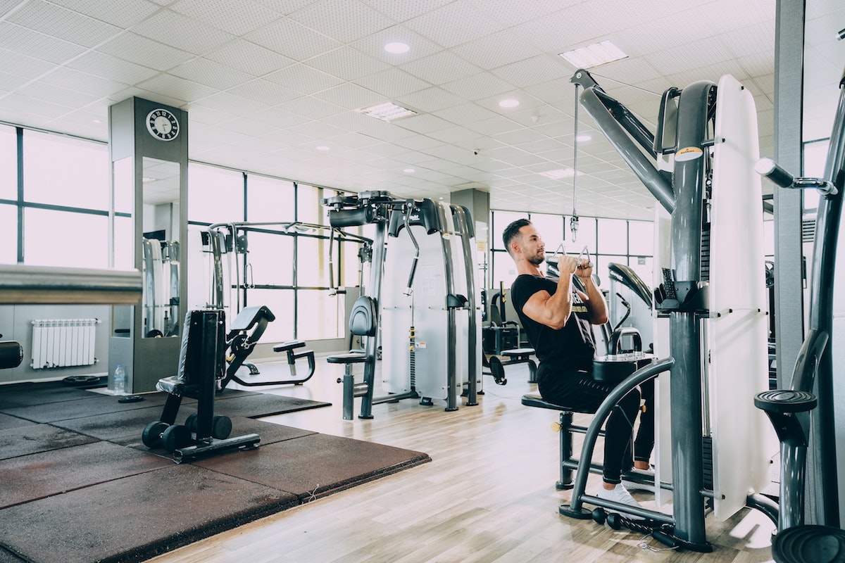 Man doing lat pull-downs in the gym