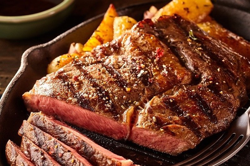 A close-up of grilled meat on a plate.