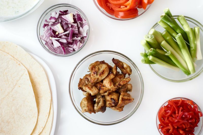 Meat and vegetables next to tortillas