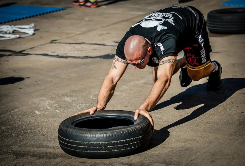 Man using tire crossfit workout