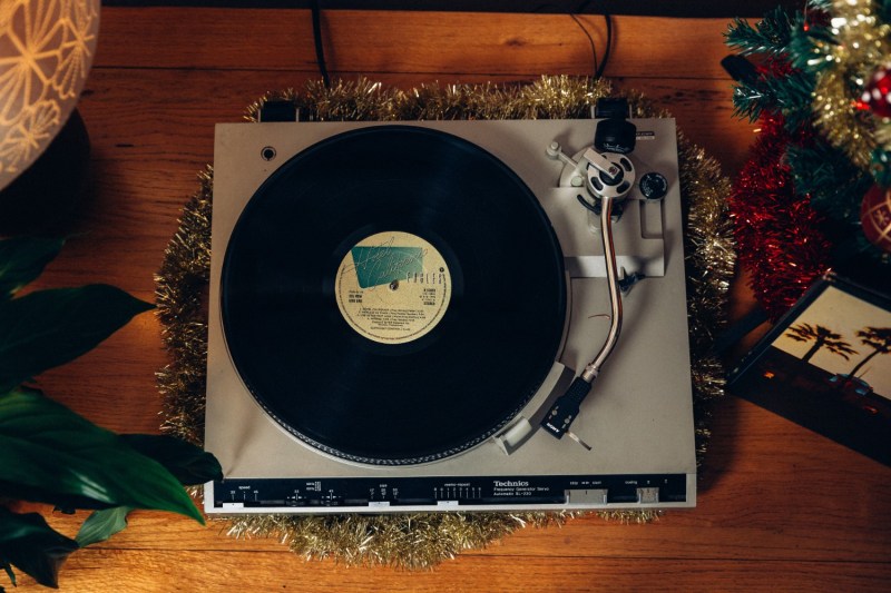 turntable with a record on it decorated with garland.