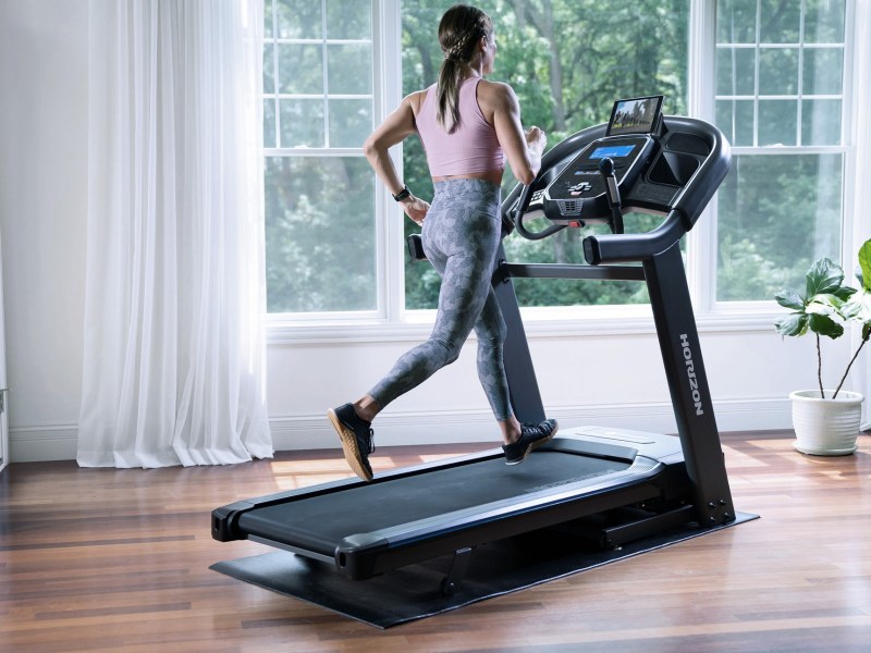 Horizon Fitness treadmill with woman working out.
