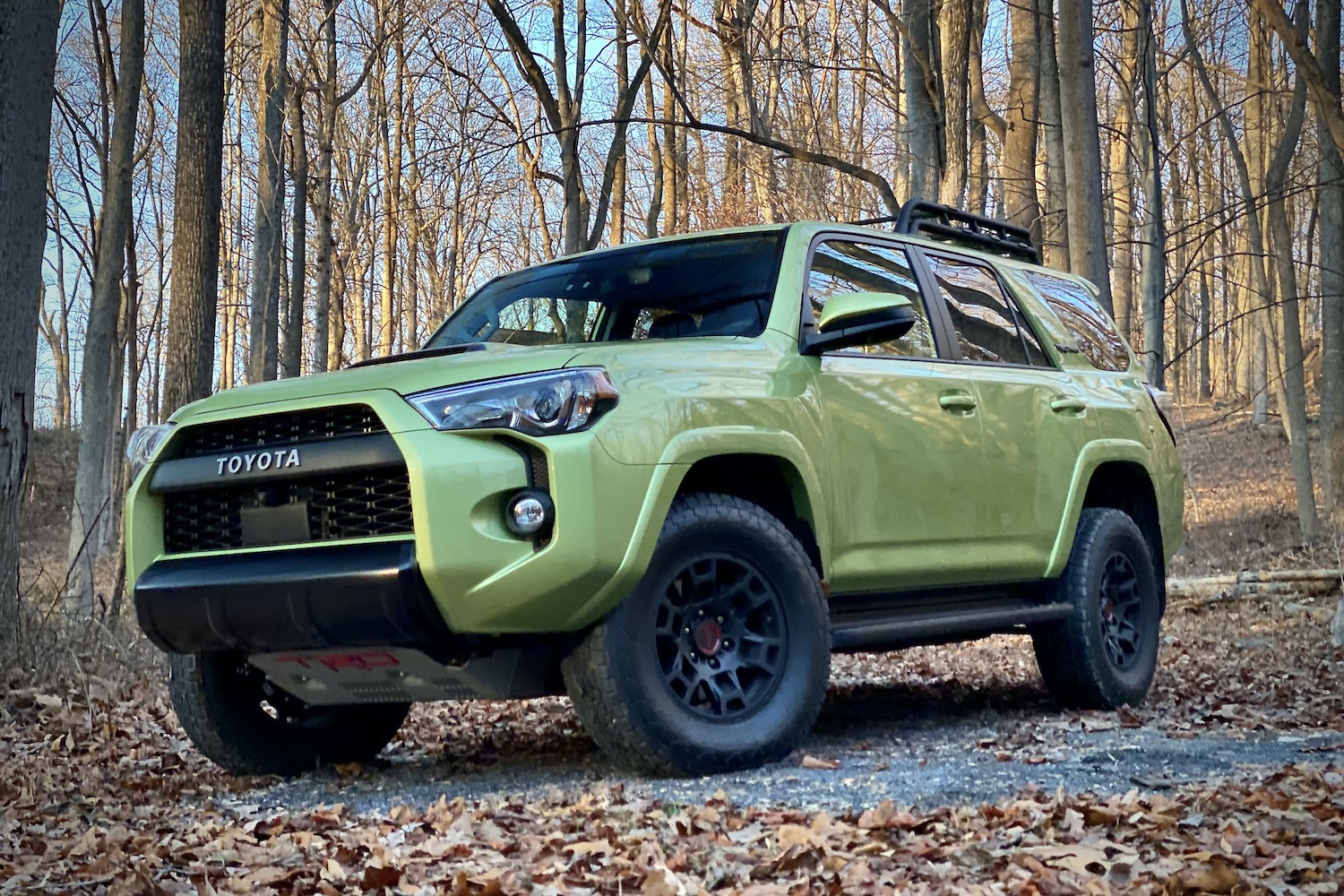 Front end angle of Toyota 4Runner TRD Pro from driver's side with trees in the back.
