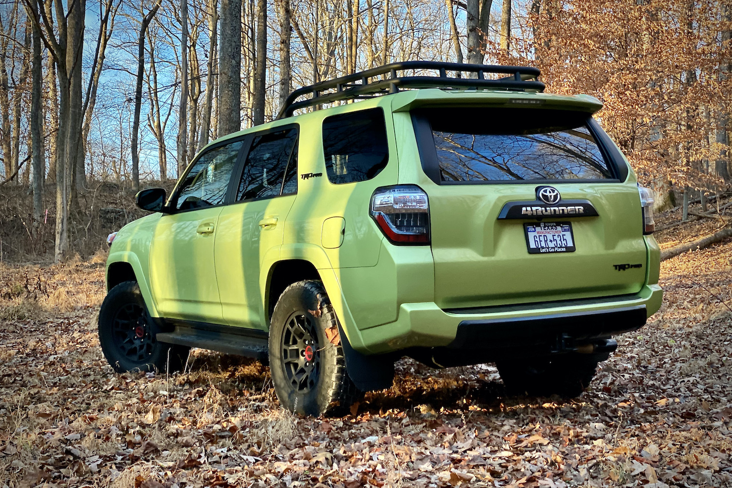 Rear end of Toyota 4Runner TRD Pro from driver's side with trees in the back.