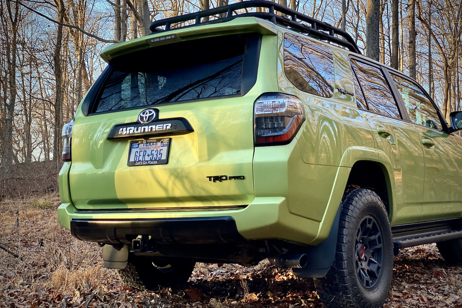 Close up of rear end of Toyota 4Runner TRD Pro with trees in the back.