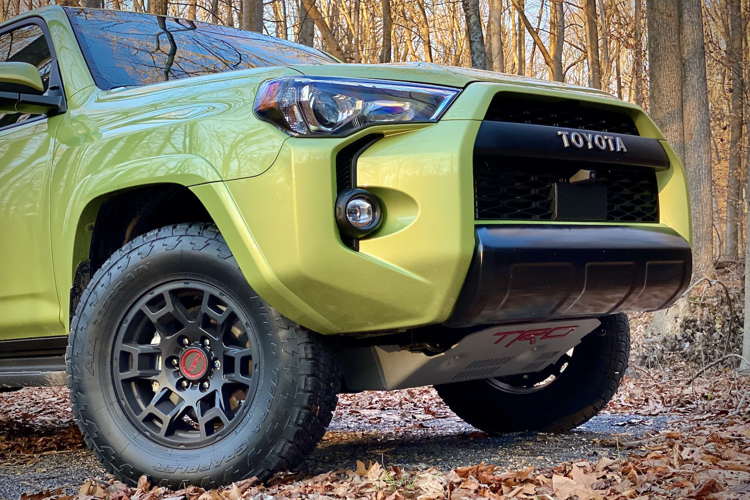 Close up of front end of Toyota 4Runner TRD Pro from passenger's side with leaves on the ground.