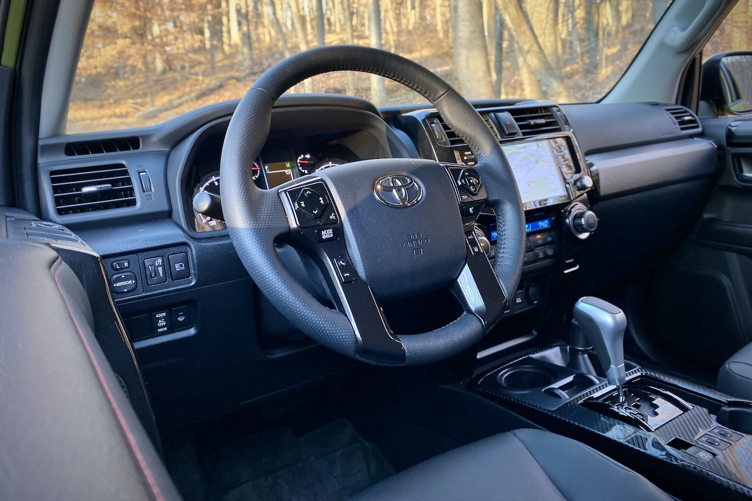 Close up of steering wheel in Toyota 4Runner TRD Pro with trees in the back.