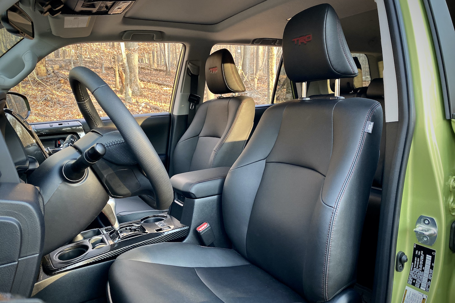 Driver's seat in Toyota 4Runner TRD Pro from outside with trees in the back.