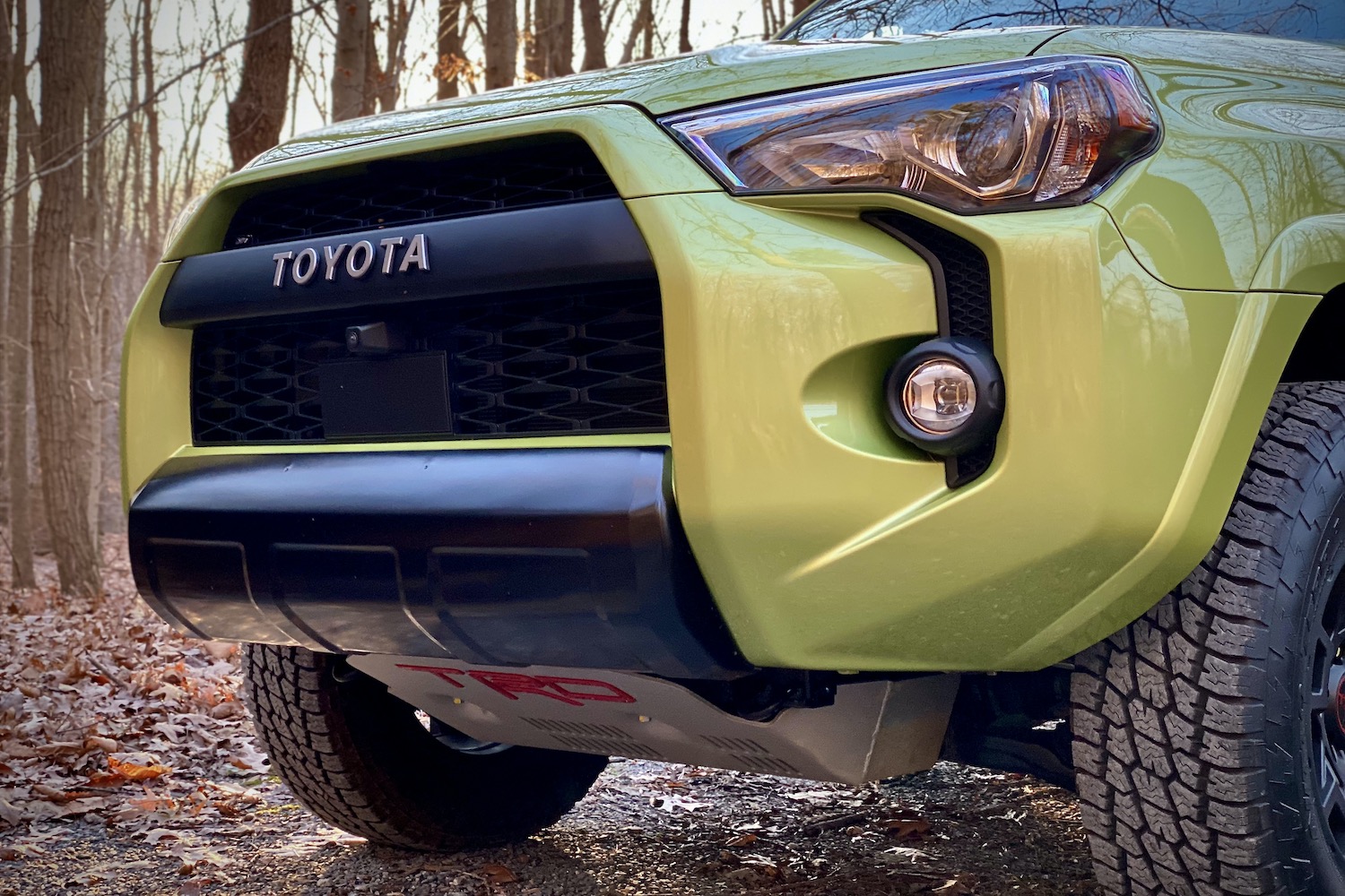 Close up of Toyota 4Runner TRD Pro front end with trees in the back.