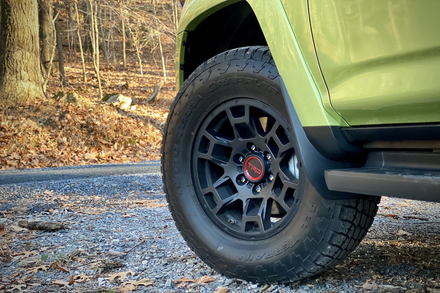 Close up of front tire on Toyota 4Runner TRD Pro on gravel path.