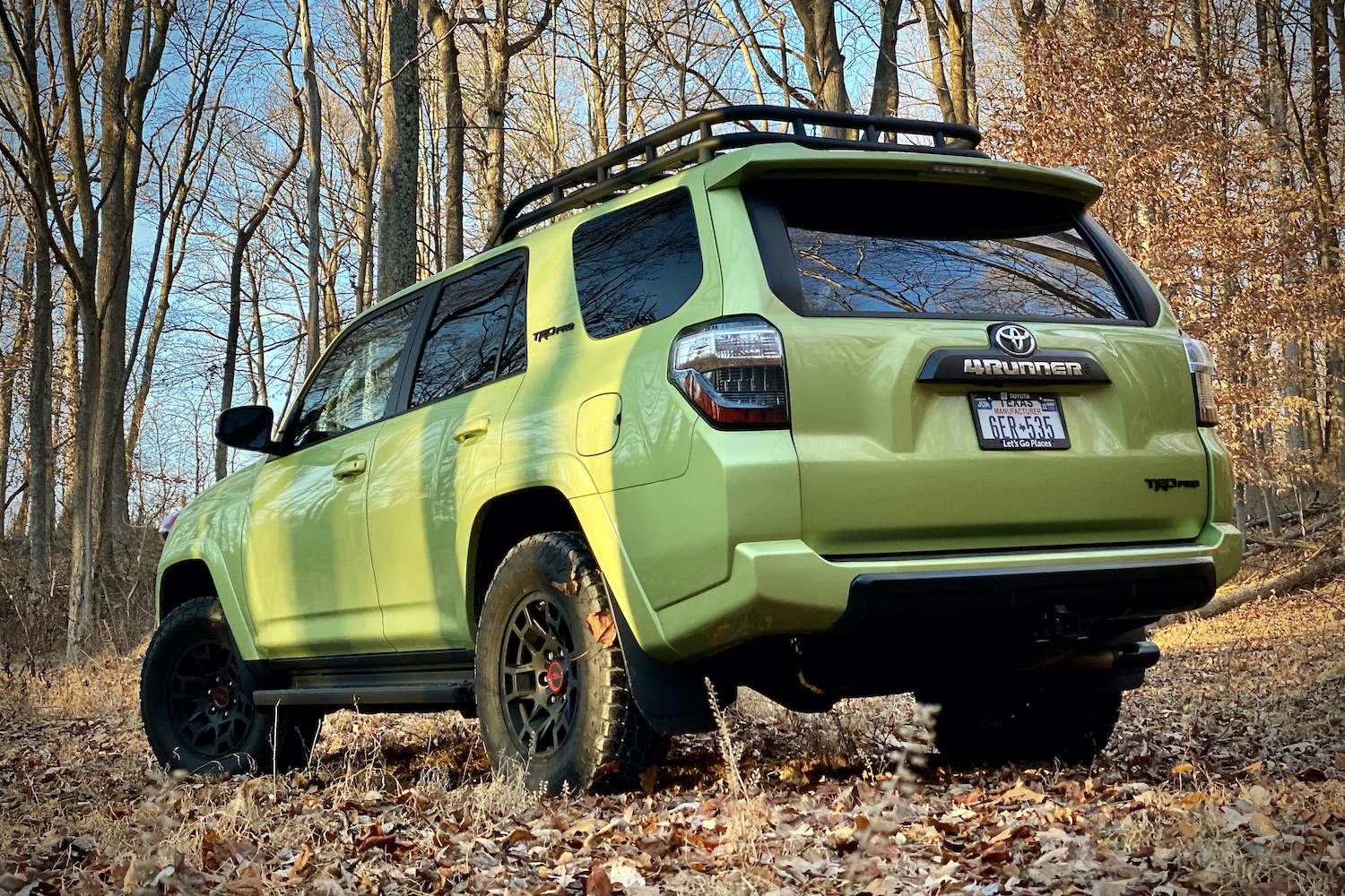 Rear angle of rear end of Toyota 4Runner TRD Pro from driver's side in front of trees.