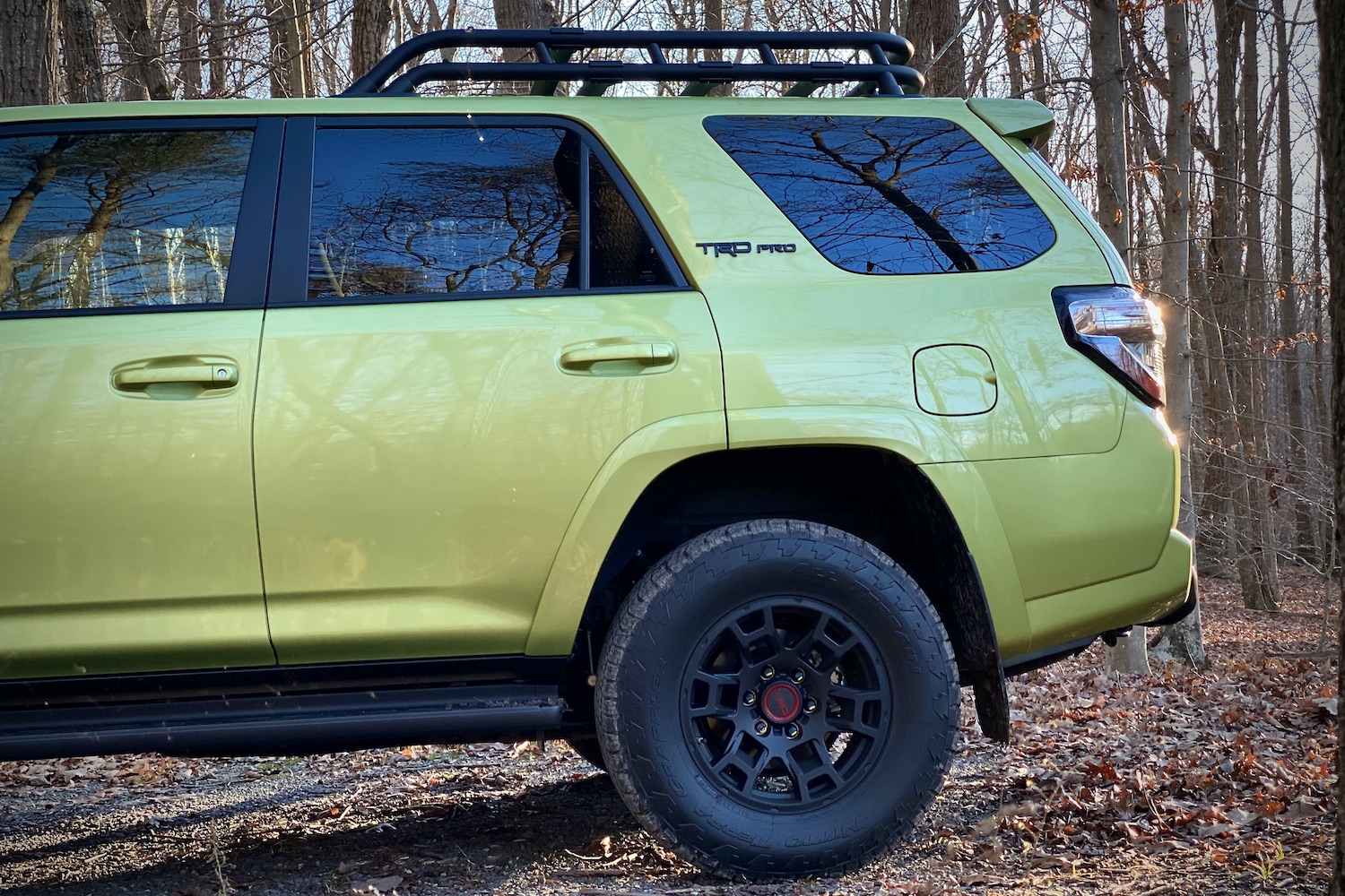 Rear end of Toyota 4Runner TRD Pro from side profile with trees in the back.