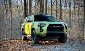 Front end of Toyota 4Runner TRD Pro from passenger's side with trees in the background.