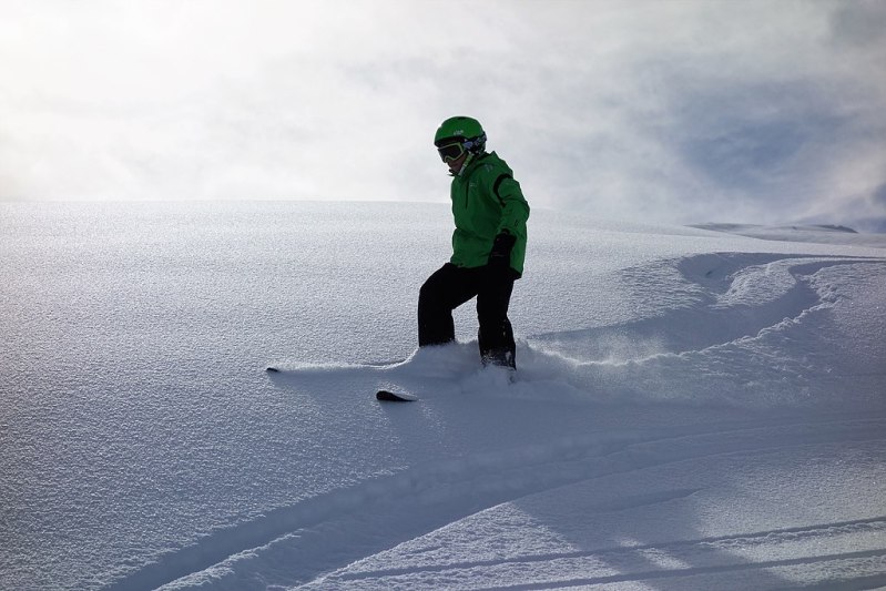 Skier skiing through fresh powder without poles.