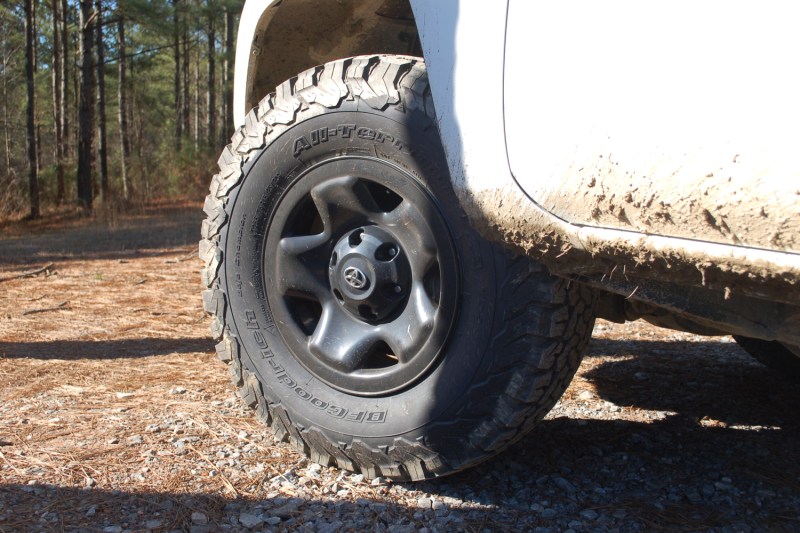 A close-up of a BFGoodrich KO2 All-Terrain Tire on a white vehicle.