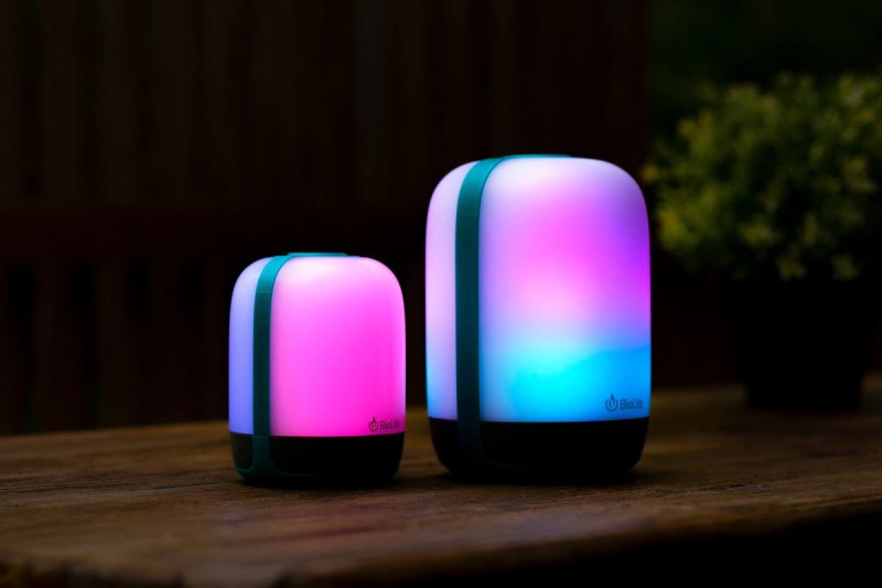 BioLite AlpenGlow Multicolor USB Lanterns on a picnic table at night.