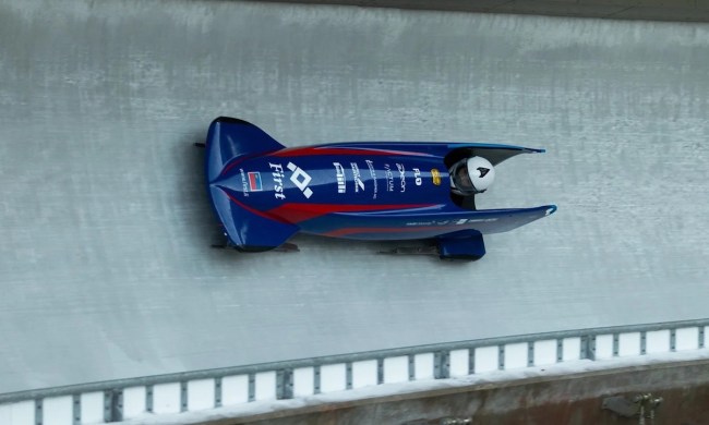 Bobsledding down a track at the Olympics.