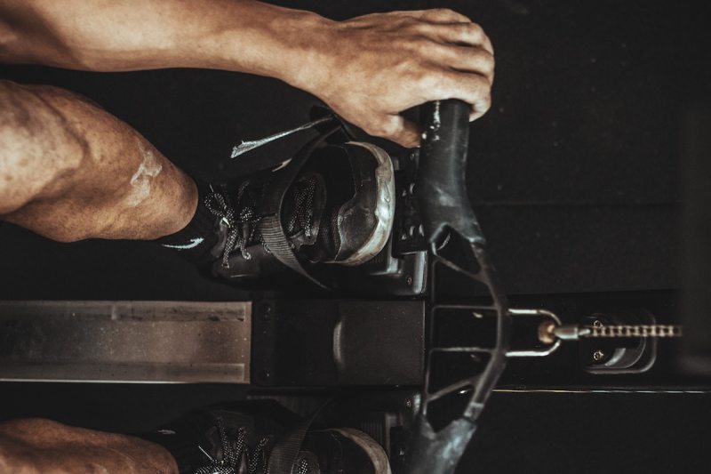 Man using rowing machine for fitness.