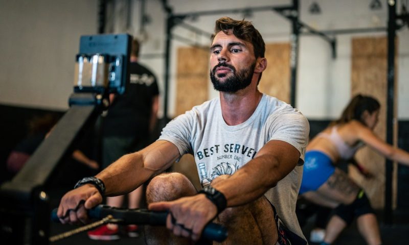 Man using a rowing machine.