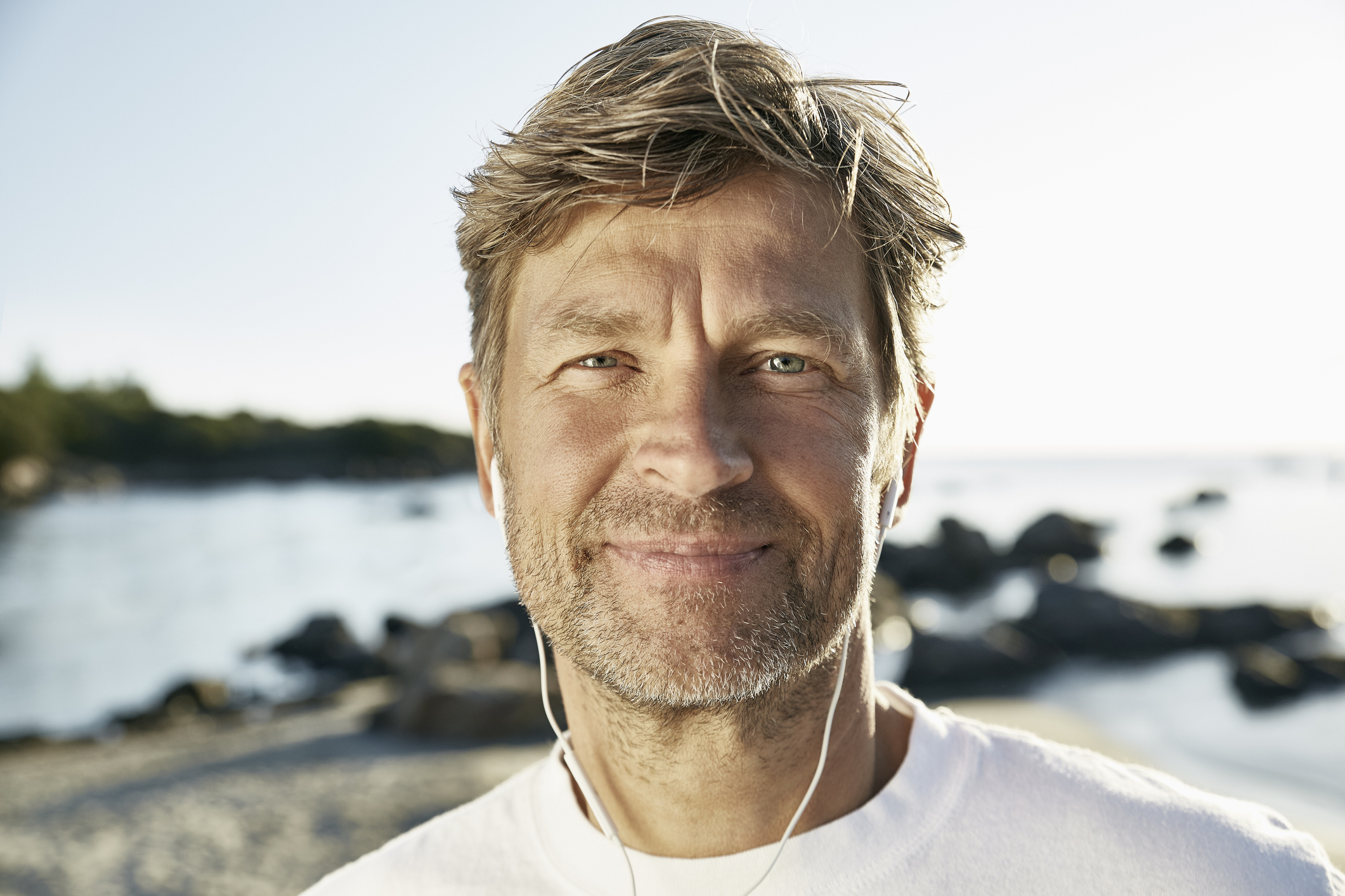 Portrait of sporty mature man with earphones.