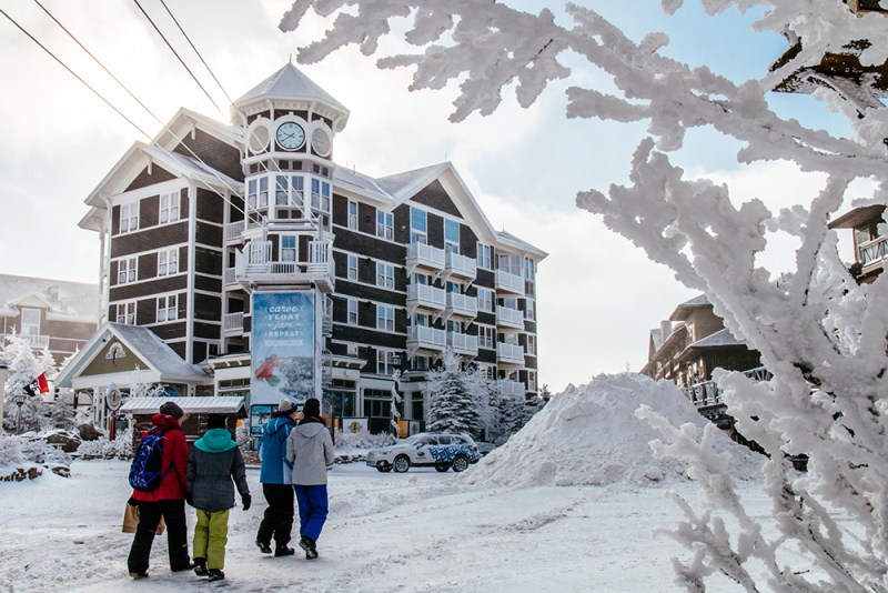 A group of people walking in front of Snowshoe resort in West Virginia.