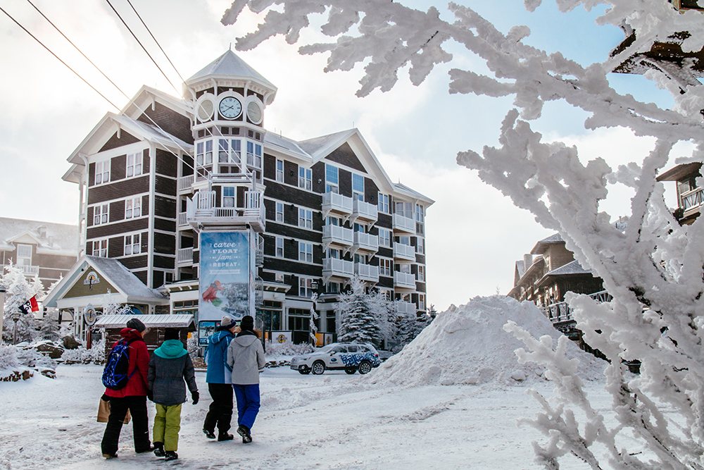 A group of people walking in front of Snowshoe resort in West Virginia.