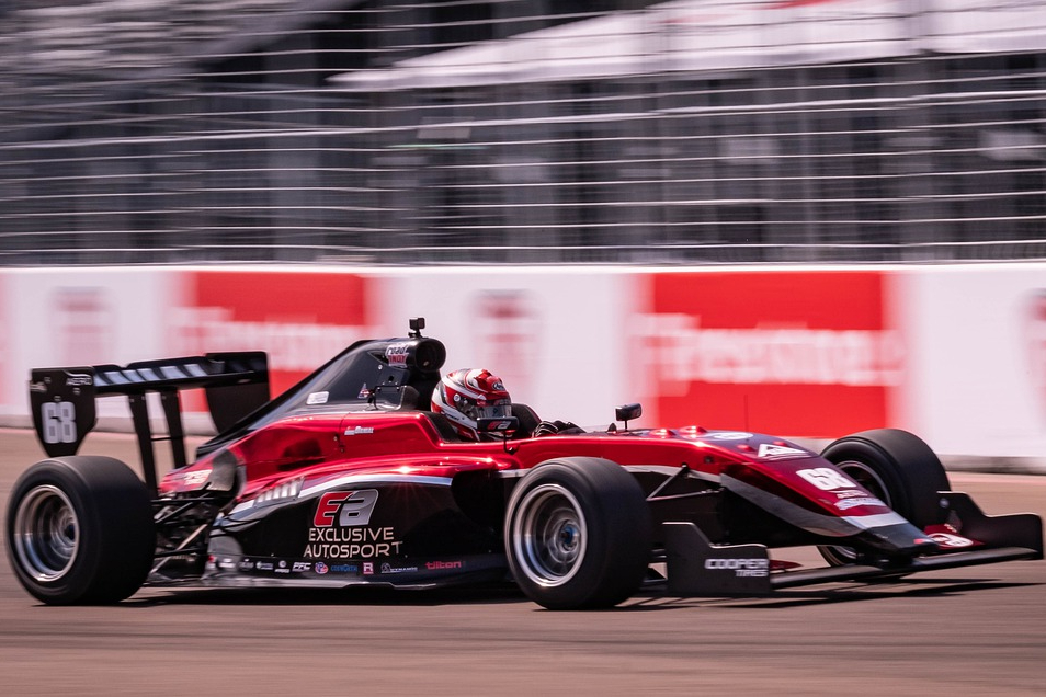 Indycar racing down straighaway.