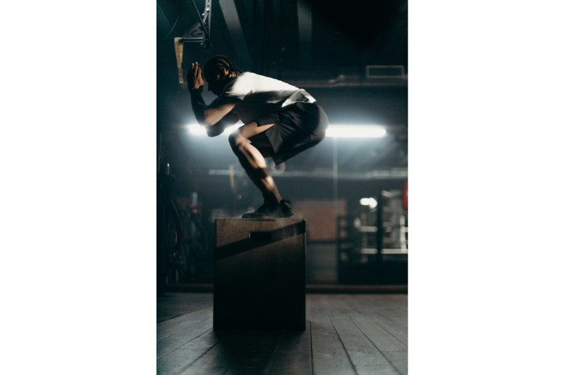 Man on a box doing a squat.