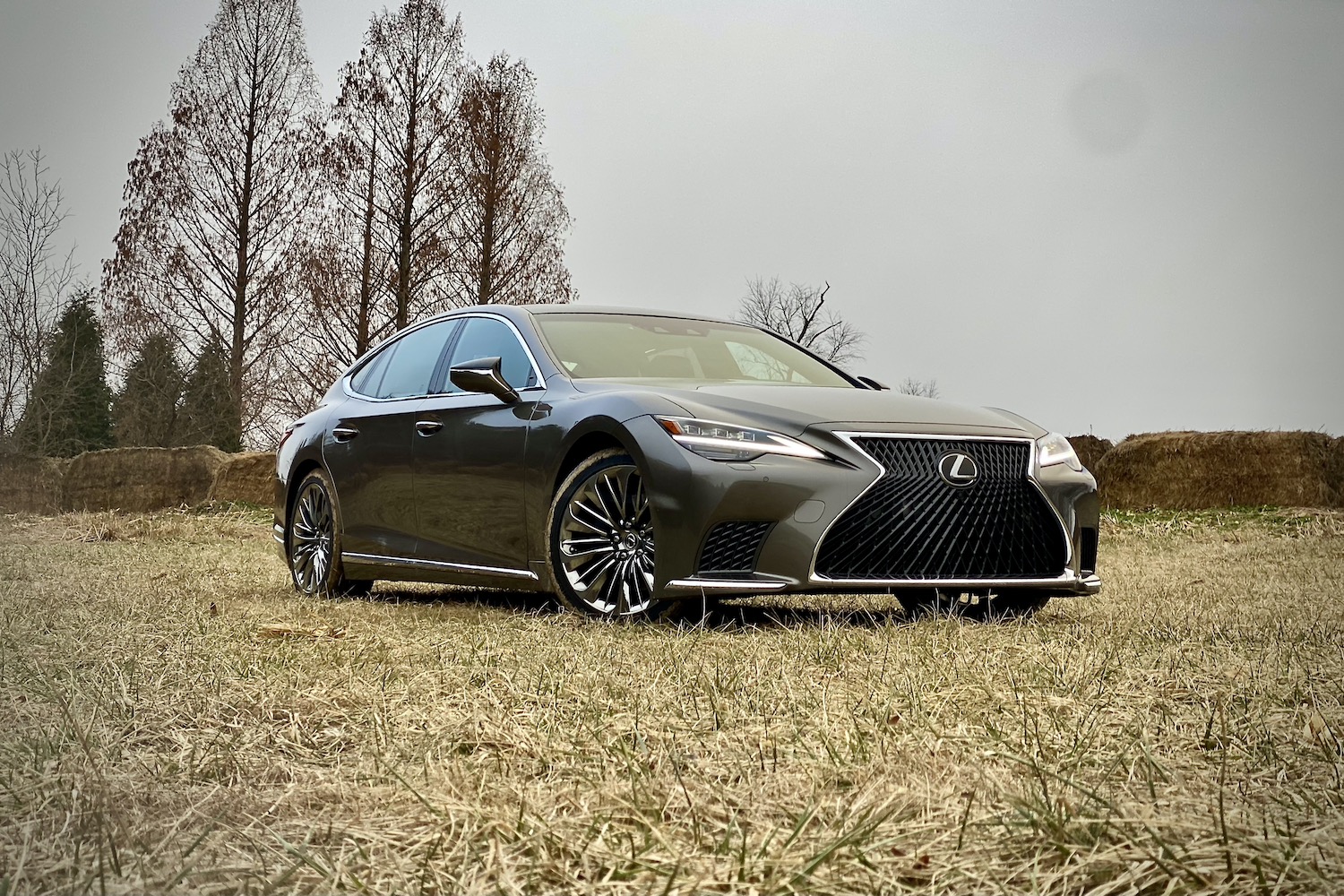 The 2021 Lexus LS500's front end from passenger's side in front of hay bales.