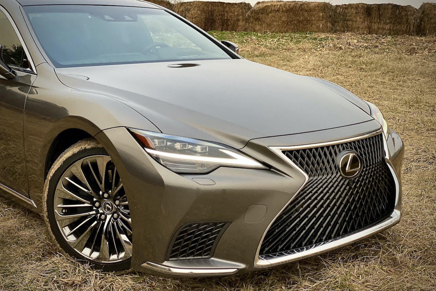 A close-up of the 2021 Lexus LS500's front end on a grassy field.