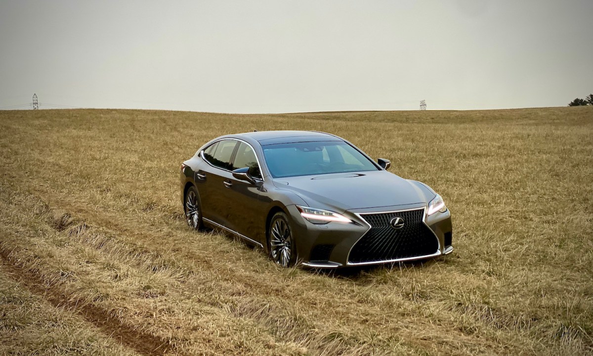 The front end of the 2021 Lexus LS500 from passenger's side in a field.