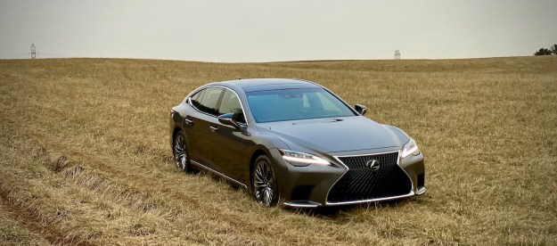 The front end of the 2021 Lexus LS500 from passenger's side in a field.