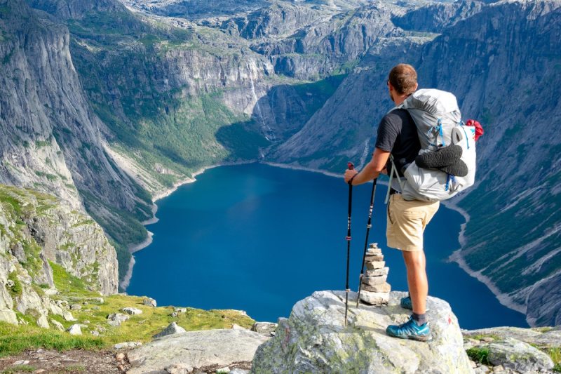 A person who walks with a beautiful view of the lake