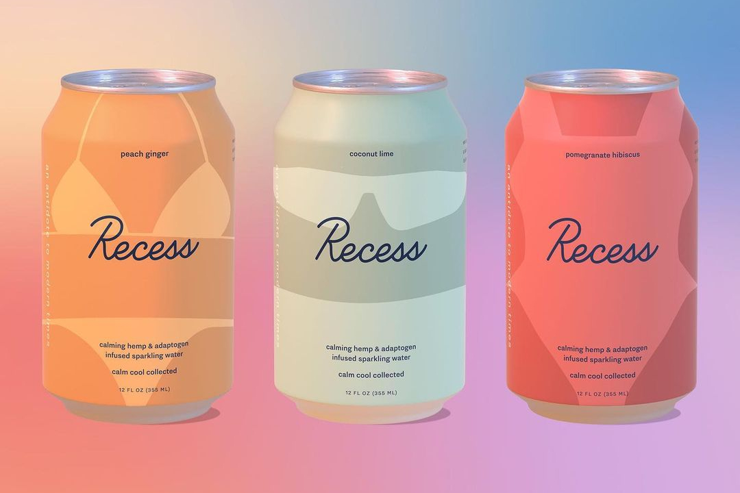 Three cans of Recess CBD beverage with a colorful orange to blue background