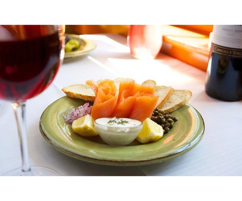 Plate of food and a glass of wine.