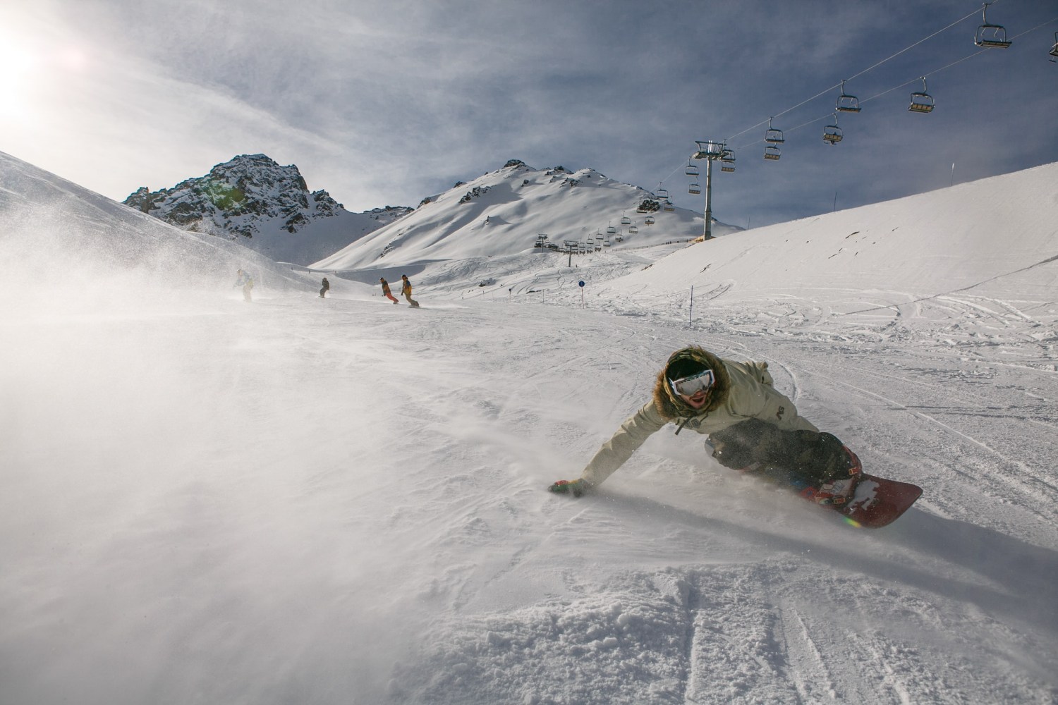 Snowboard cruises down run
