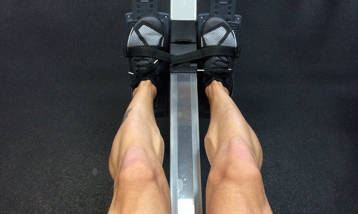 A man's strong legs from rowing.