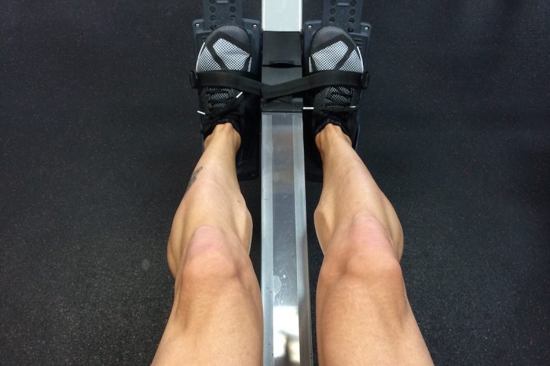 A man's strong legs from rowing.