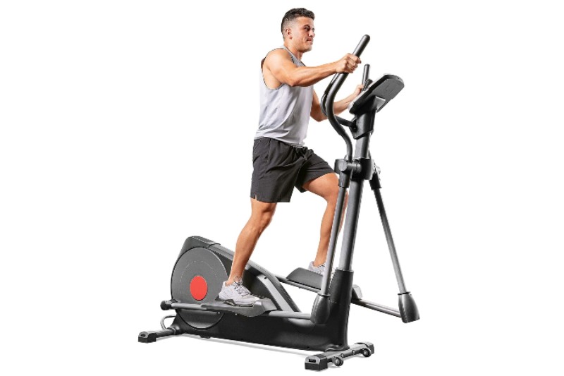 Man using the Sunny Health & Fitness pre-programmed elliptical trainer.