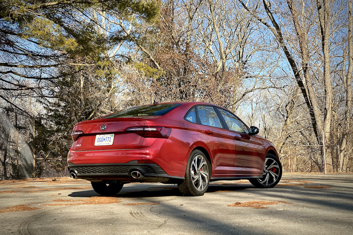 Rear end of 2022 Volkswagen Jetta from the passenger's side with trees in the background.