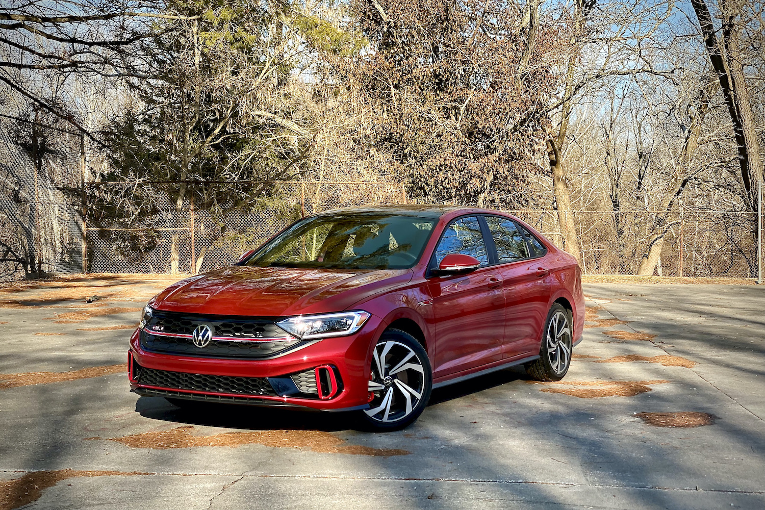 Front end of 2022 Volkswagen Jetta from driver's side with trees in the background.