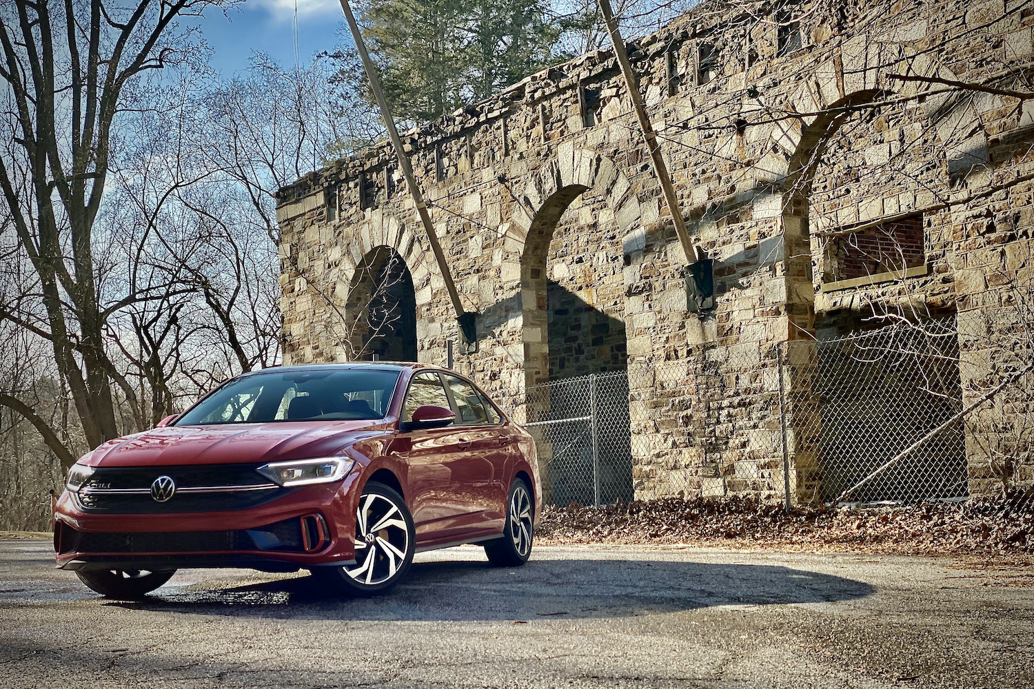 2022 Volkswagen Jetta front end from driver's side in front of an abondoned building.