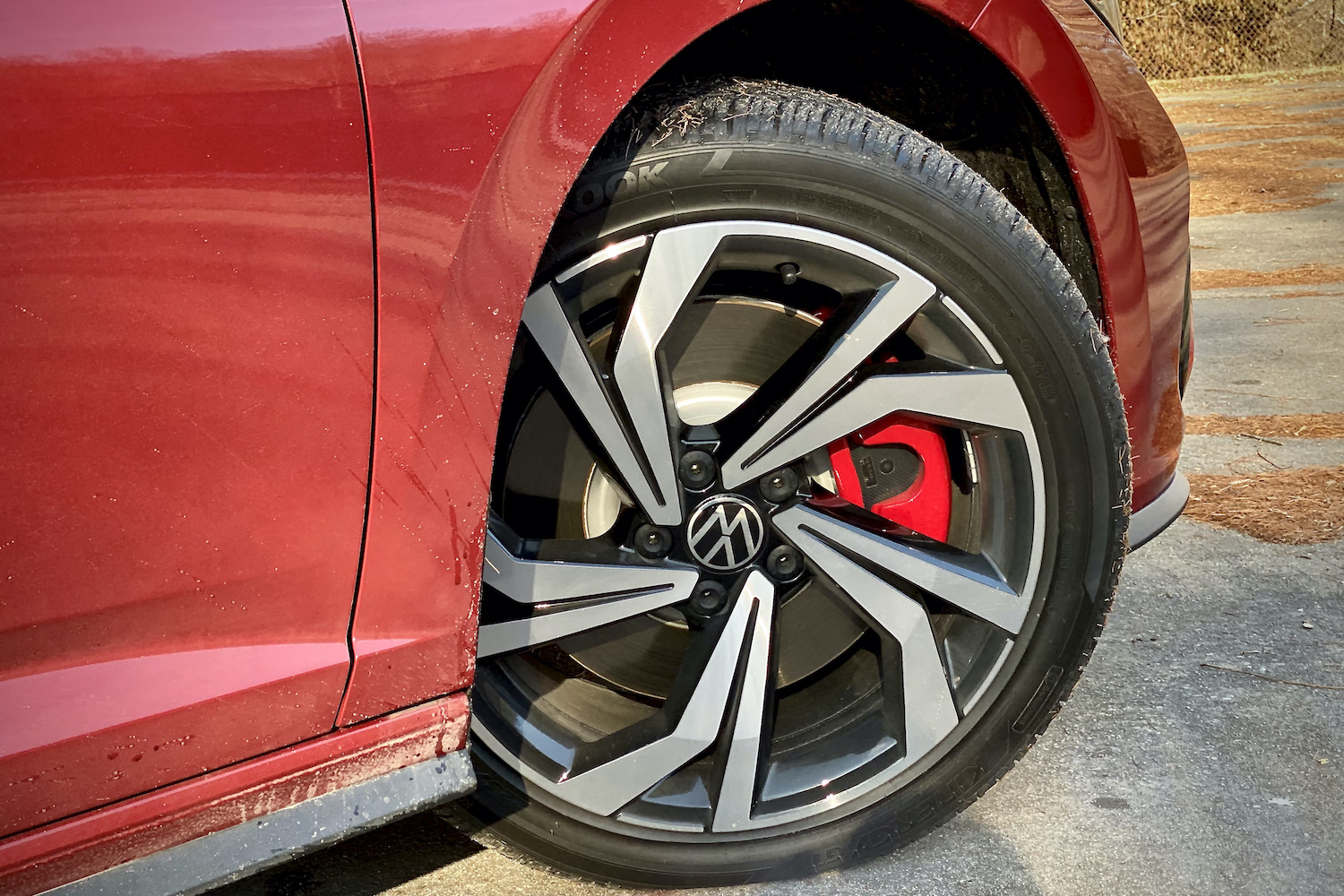 Front wheel of 2022 Volkswagen Jetta on a concrete parking lot.