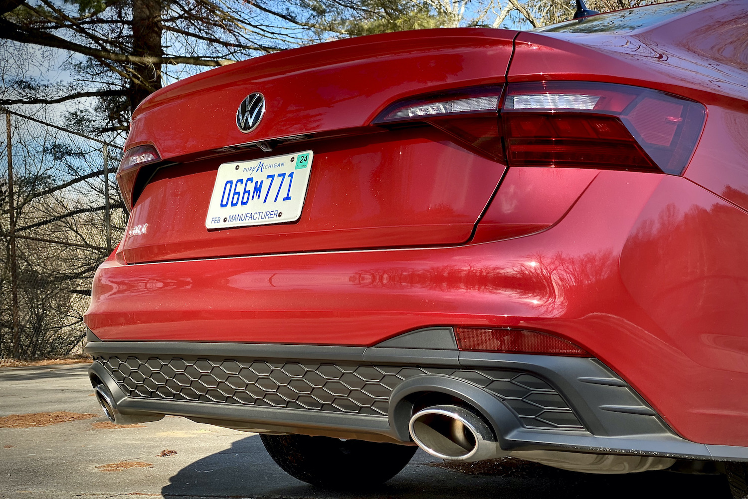 Close up of 2022 Volkswagen Jetta rear end, rear diffuser, and exhaust outlets.