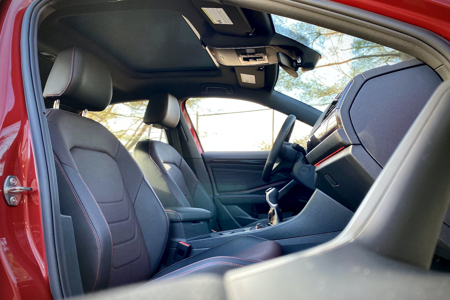 Front seats in 2022 Volkswagen Jetta GLI from inside of door handle.