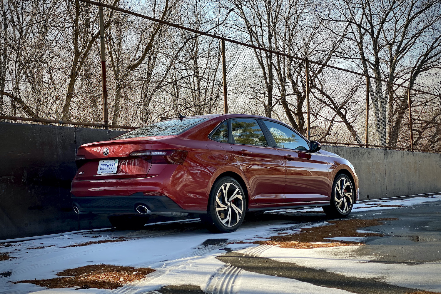 Side profile of 2022 Volkswagen Jetta GLI from passenger side in a snowy parking lot.