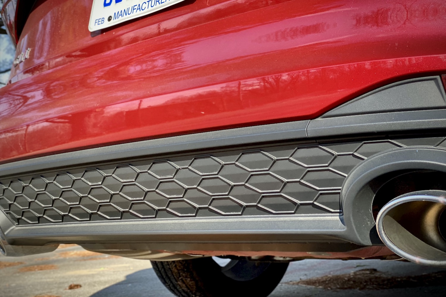 Close up of 2022 Volkswagen Jetta GLI honeycomb rear diffuser and exhause outlet.