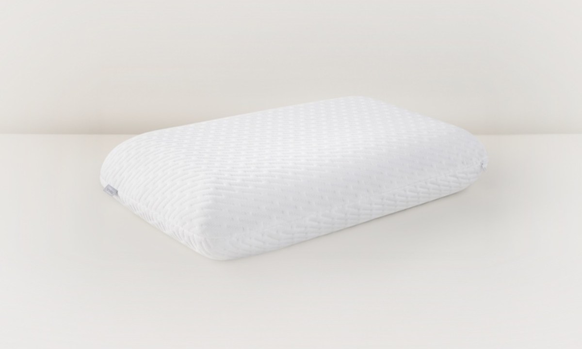 A Tuft & Needle pillow against a cream background.