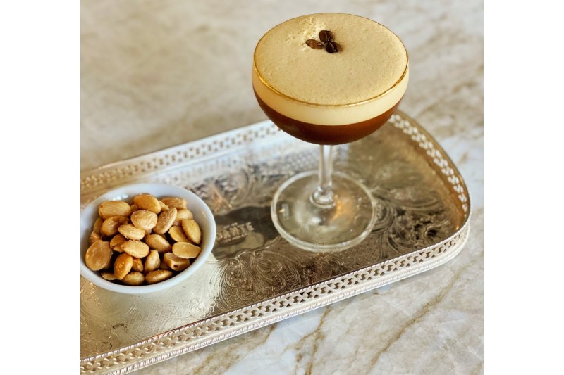 Amaro Averna Sicilian espresso martini on a serving tray next to toasted almonds.