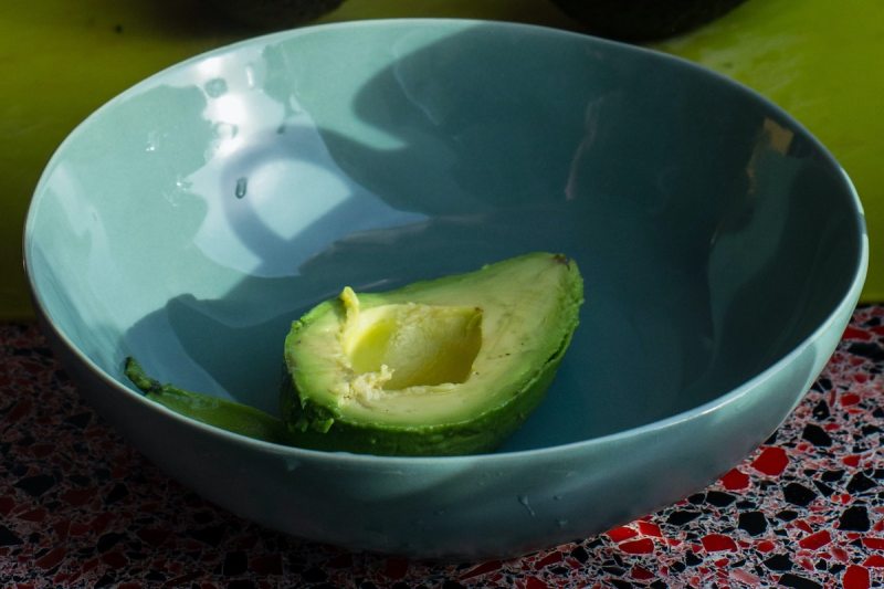Half avocado in a bowl